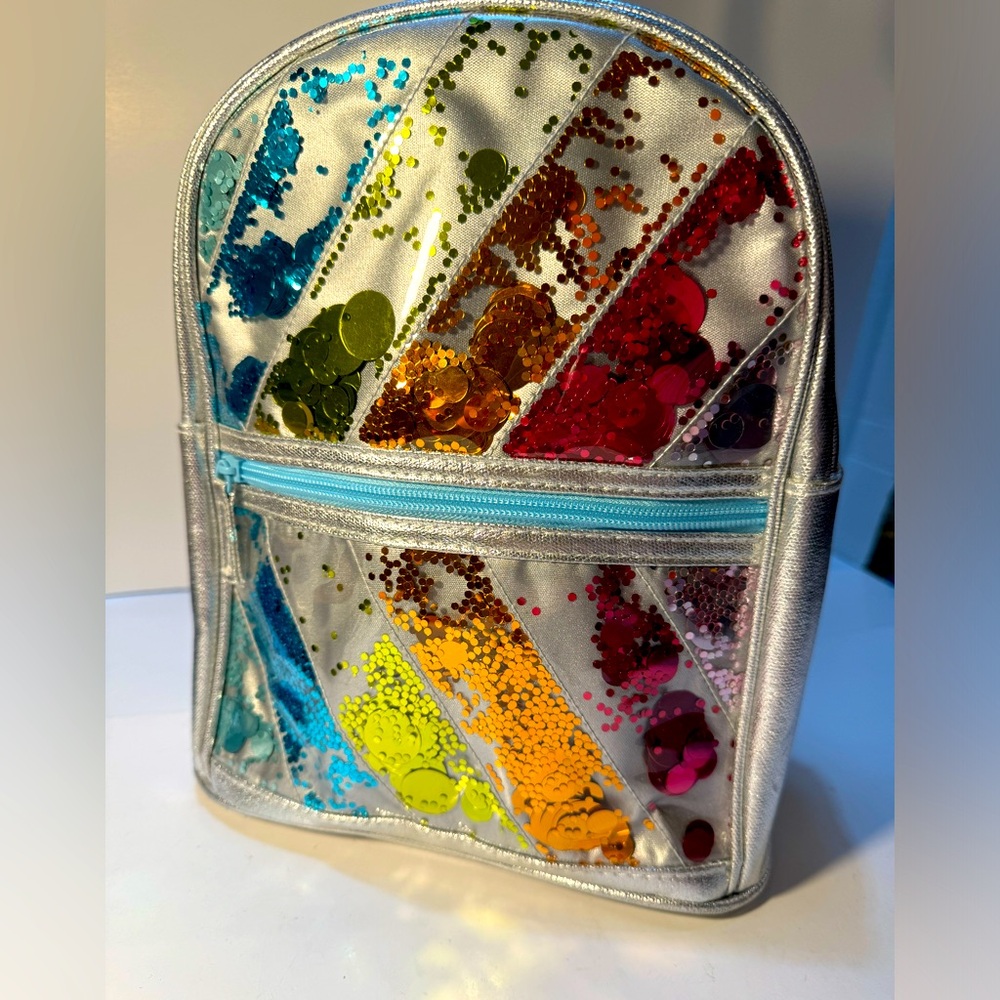 backpack with blue adjustable straps, multicolored design 11x8.5x3”